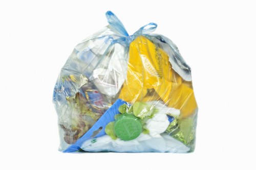 Operative wearing protective equipment beside commercial bins