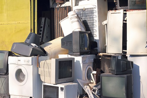 Workers wearing PPE handling waste containers during a commercial collection